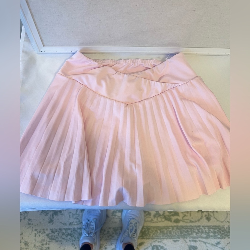 Criss Cross Waist Band, pleated pink tennis skirt with built in shorts!